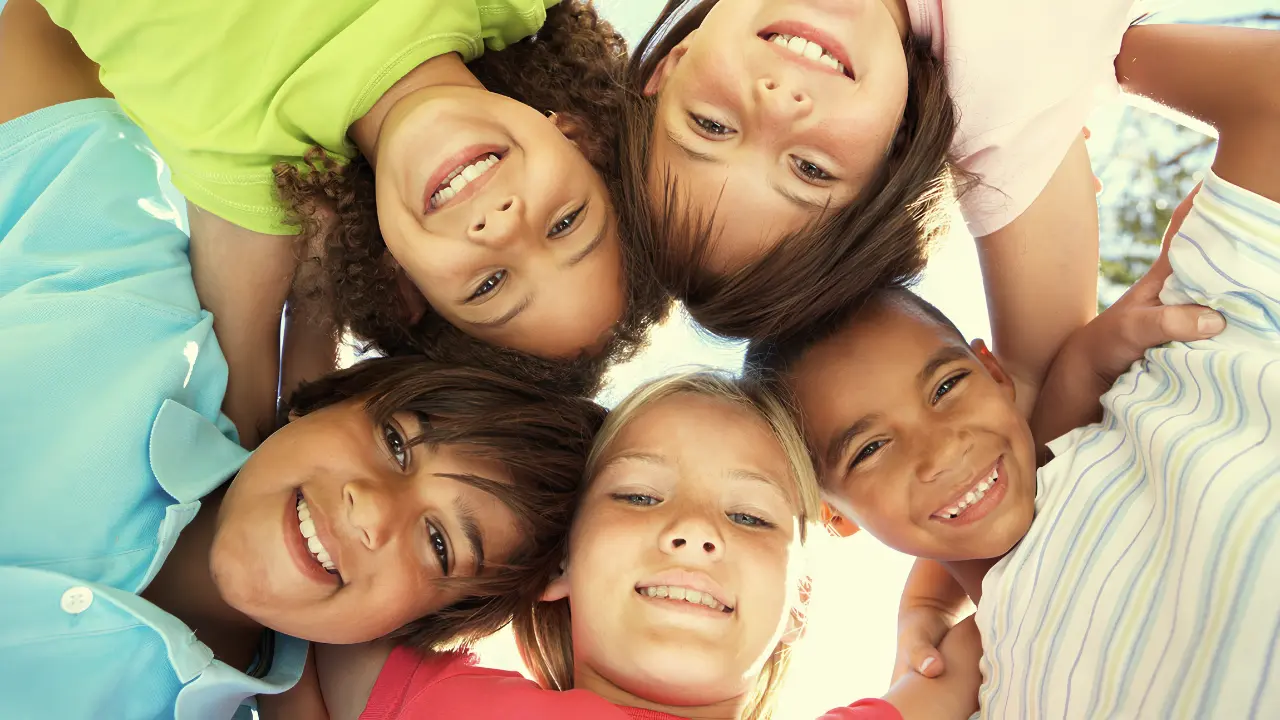 A group of children huddled together in circle