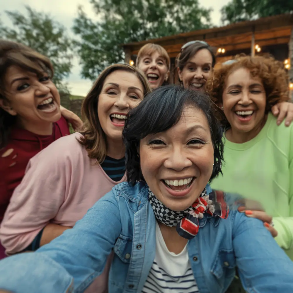 Group of middle age women having fun outside