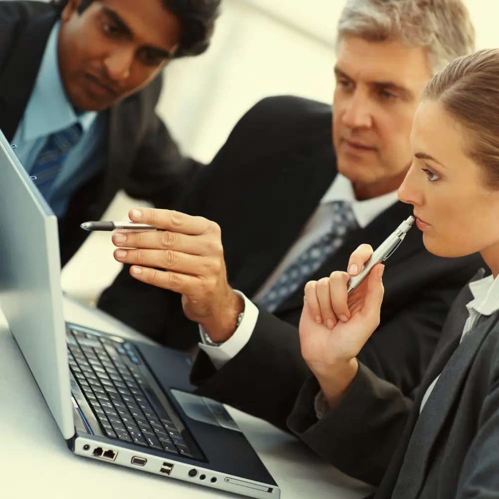Business group making a decision while viewing laptop screen