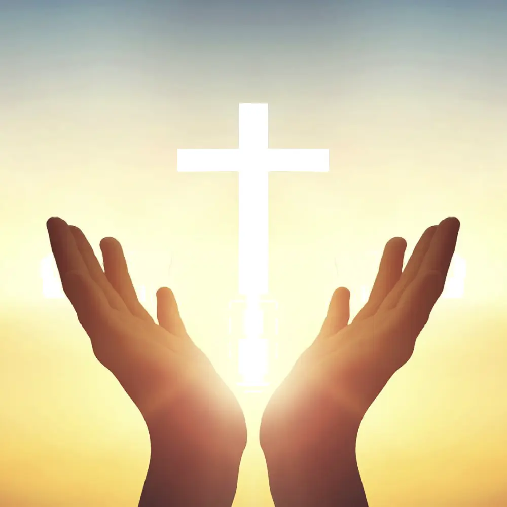Hands below glowing cross