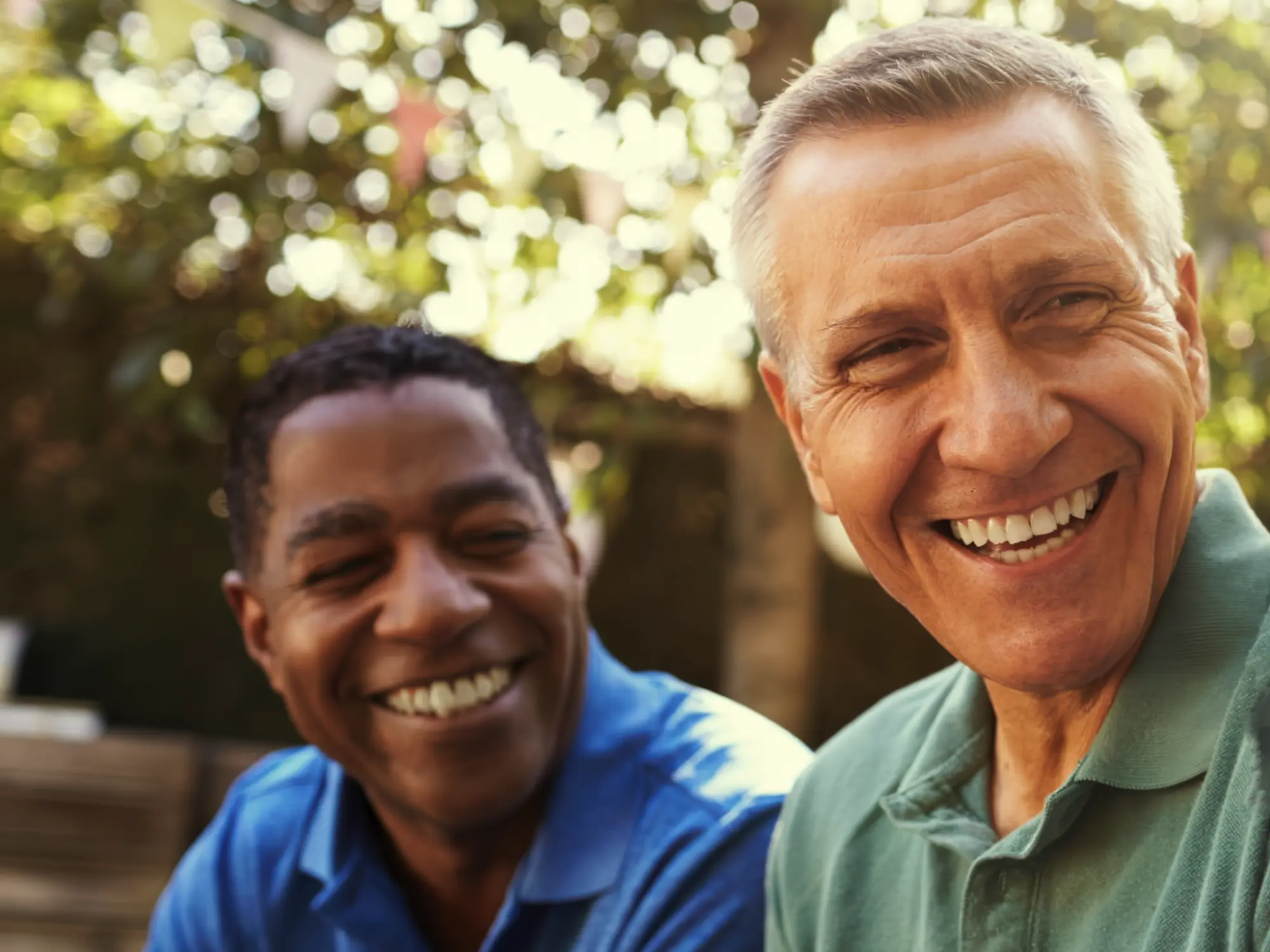 Two middle aged men smiling