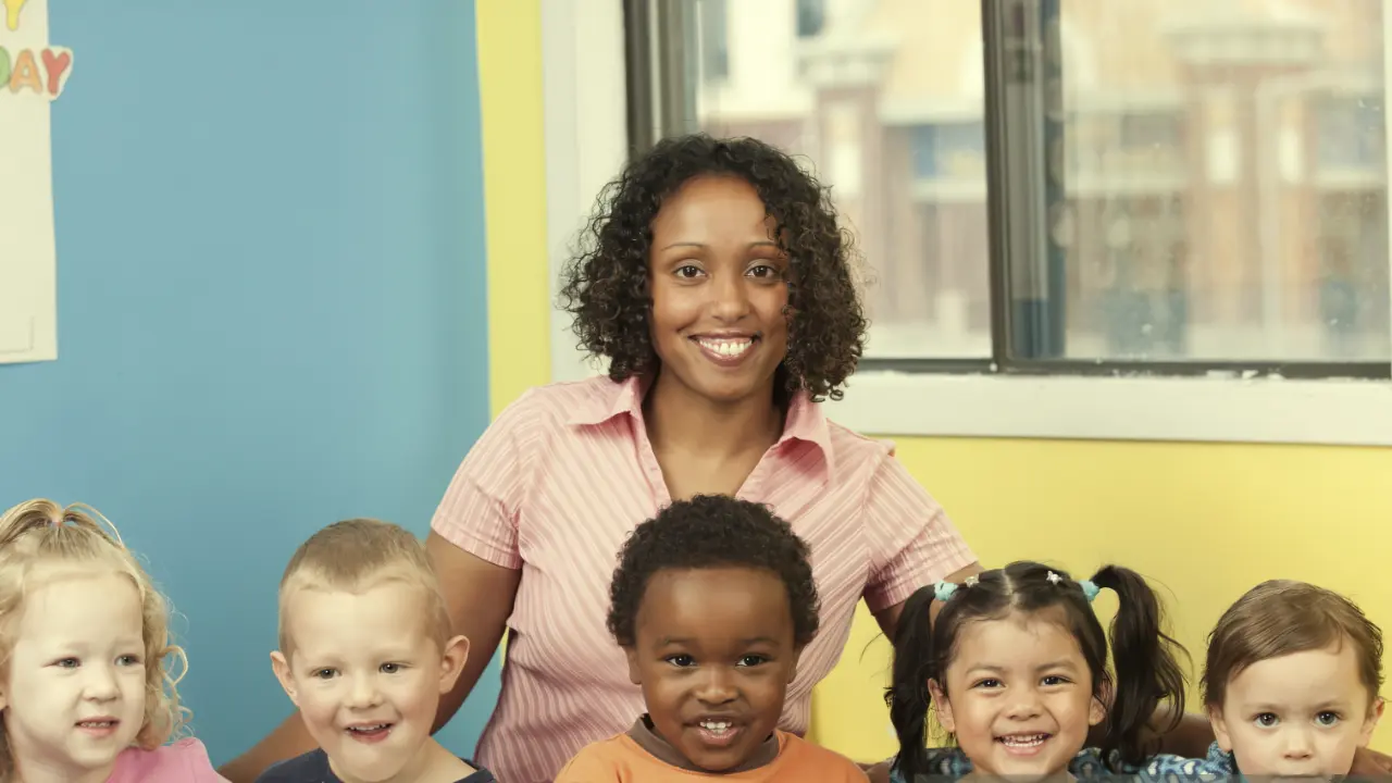 Teacher in classroom with young children