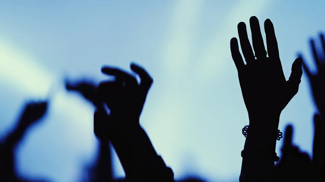 Crowd of hands raised in the air